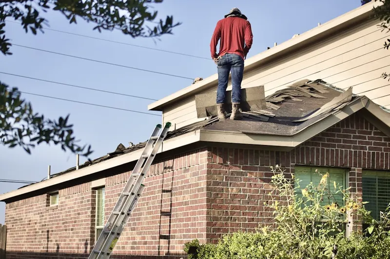 Professional roofer working on a residential roof in Rosenhayn